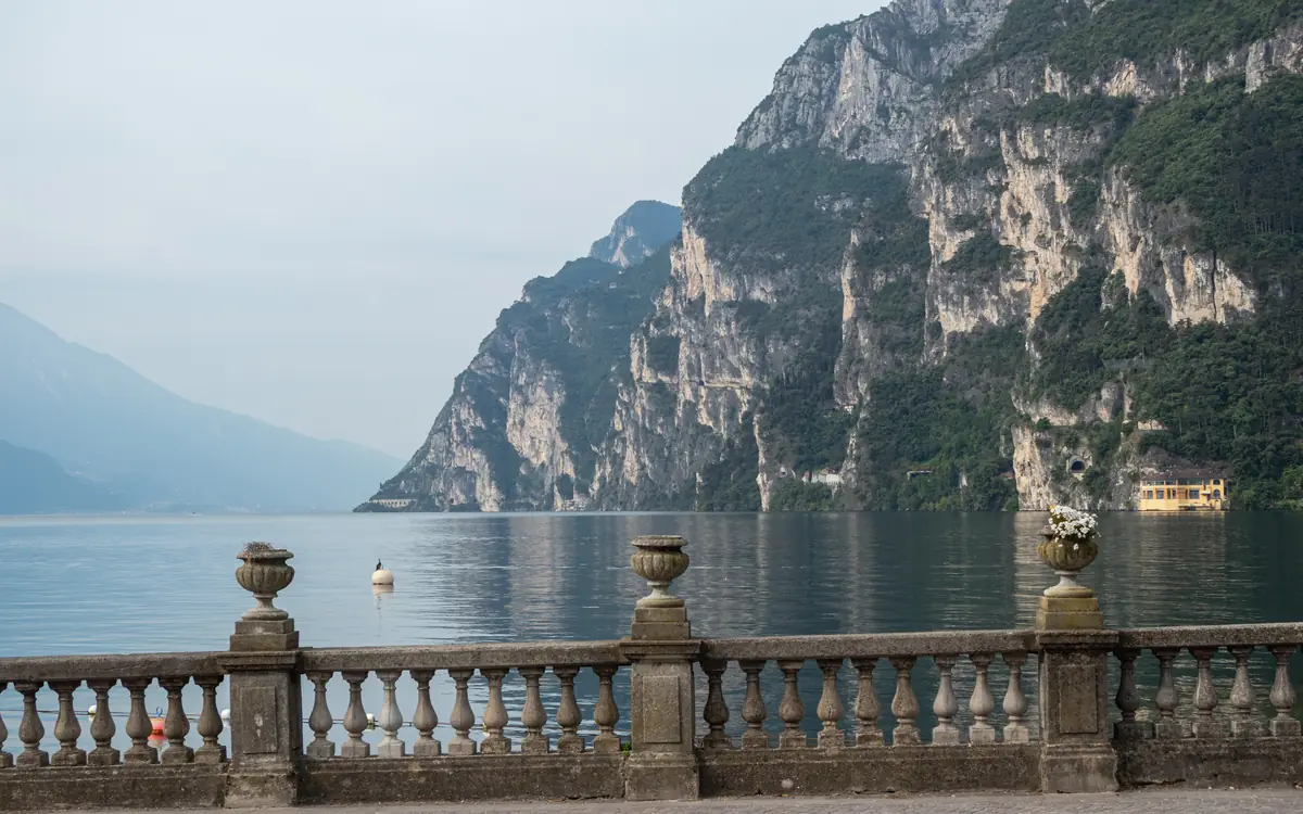 Lake Garda waterfront below steep mountain cliffs at Riva del Garda.