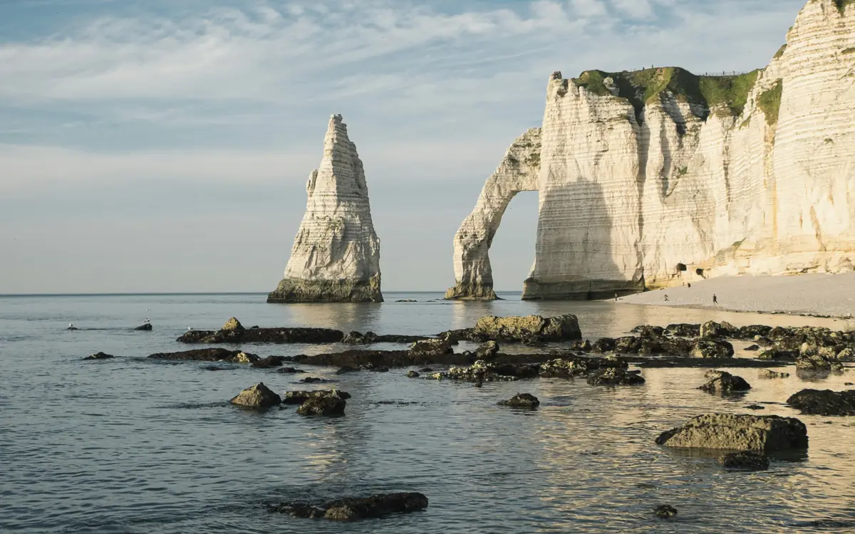 Chalk cliffs and sea arch at Étretat cliffs.