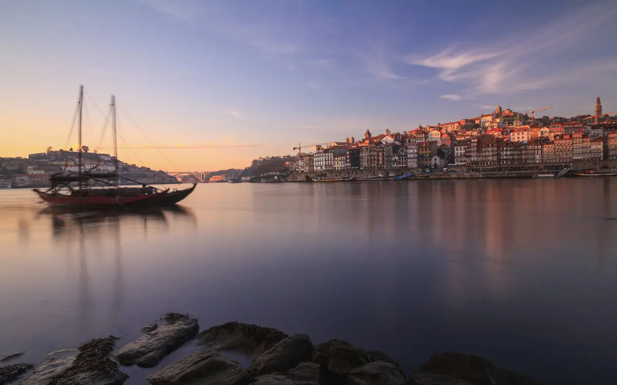 Porto riverfront with traditional boat at Douro riverfront / Ribeira.